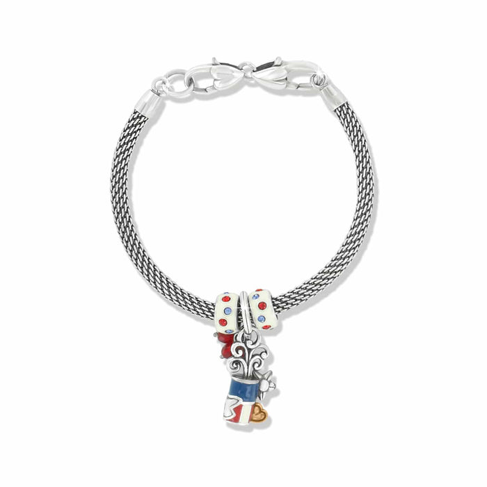 Brighton silver-plated mesh charm bracelet with red, white, and blue enamel charms and crystal beads on a white background