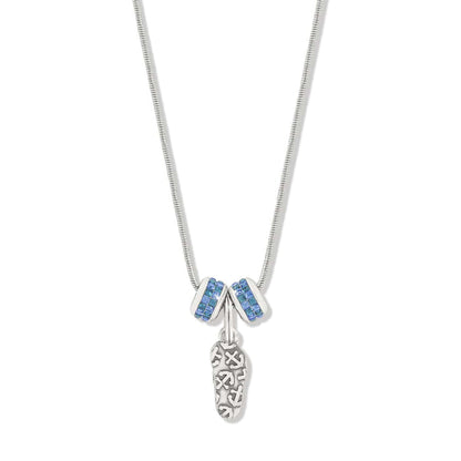 Brighton charm necklace with silver-plated sandal pendant and two blue crystal rondelle charms on a white background