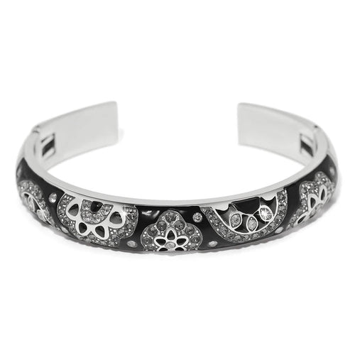 Brighton cuff bracelet with black enamel, silver-plated floral motifs, and crystal accents on a white background