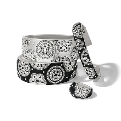 Brighton silver-plated bangles and ring set with black and white enamel and crystal floral medallions on a white background
