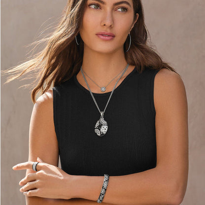 Model wearing a Brighton silver-plated pendant necklace with black enamel and crystals, paired with coordinating Brighton accessories