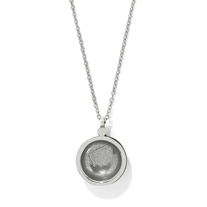 Brighton pendant necklace with round silver-plated medallion and recessed center on delicate chain on a white background