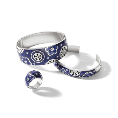 Brighton bangle bracelets and ring set with blue enamel, floral motifs, crystals, and silver-plated finish on a white background