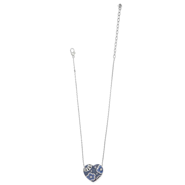 Brighton heart pendant necklace with blue enamel floral design, crystal accents, and silver-plated chain on a white background