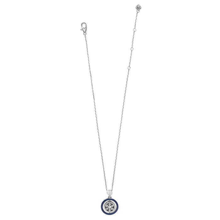 Brighton pendant necklace with silver-plated chain and round blue enamel medallion with crystal accent on a white background