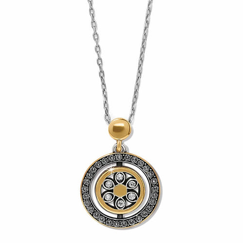 Brighton pendant necklace with two-tone circular medallion, crystal accents, and floral center on a white background