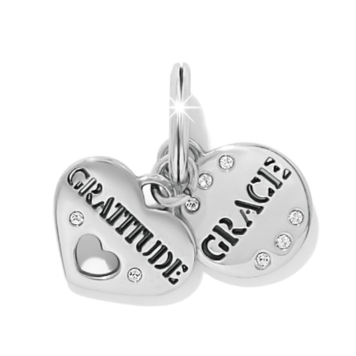 Brighton silver-plated heart charms engraved with Gratitude and Grace, accented with crystals, on a white background