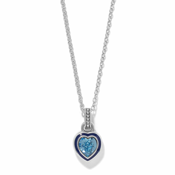 Brighton pendant necklace with silver-plated heart, blue enamel border, and blue crystal center on a white background