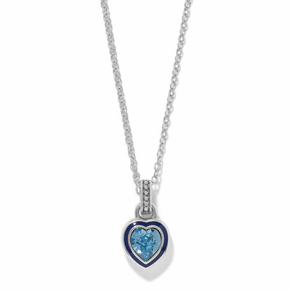 Brighton pendant necklace with silver-plated heart, blue enamel border, and blue crystal center on a white background