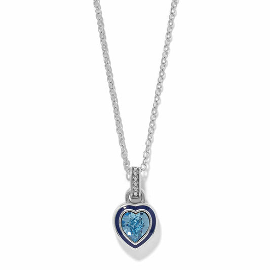Brighton pendant necklace with silver-plated heart, blue enamel border, and blue crystal center on a white background