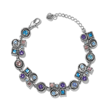 Brighton bracelet with blue, purple, and pink crystals in silver-plated circular and square settings on a white background