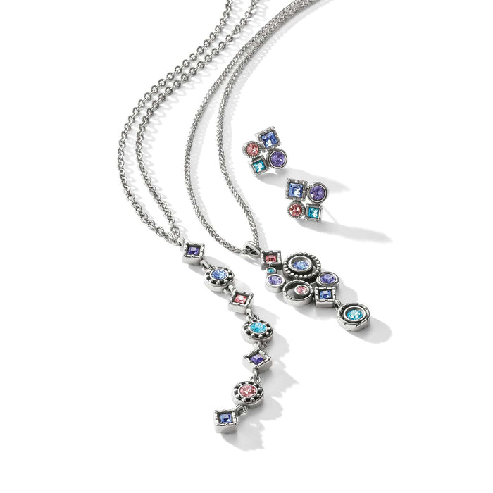 Brighton silver-plated necklaces and earrings styled together with multicolor crystal accents in geometric shapes on white background