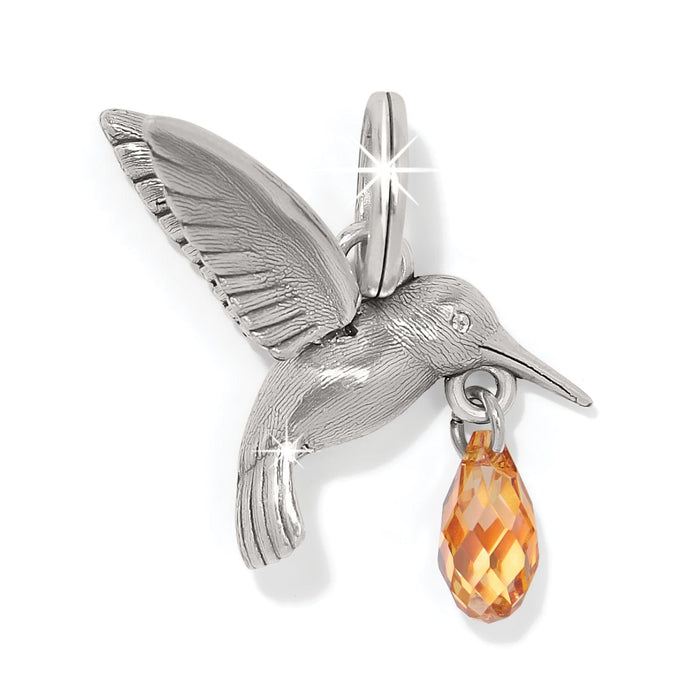 Brighton hummingbird charm in silver-plated finish with dangling orange faceted crystal teardrop on a white background