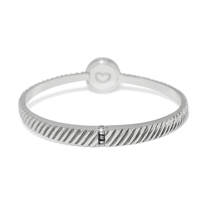 Brighton bangle bracelet with silver-plated ribbed texture and round charm featuring engraved heart detail on a white background