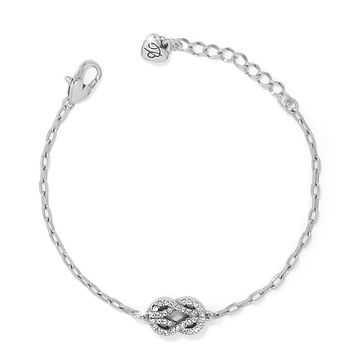 Brighton silver-plated chain bracelet with crystal-encrusted infinity knot charm and heart-tag extender on a white background