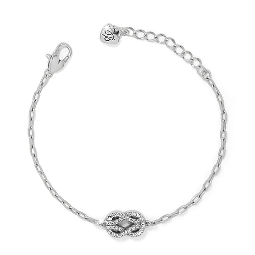 Brighton silver-plated chain bracelet with crystal-encrusted infinity knot charm and heart-tag extender on a white background