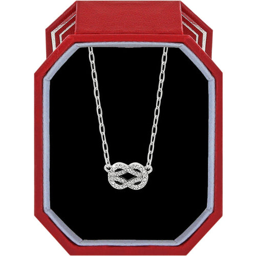 Brighton silver-plated necklace with crystal infinity knot pendant displayed in a red gift box on a white background