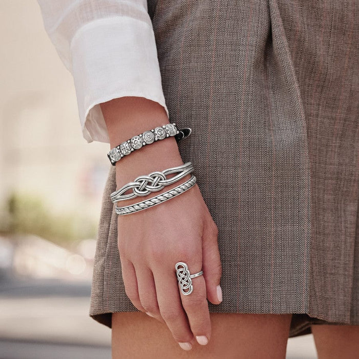 Model in brown wearing Interlok Hinged Bangle