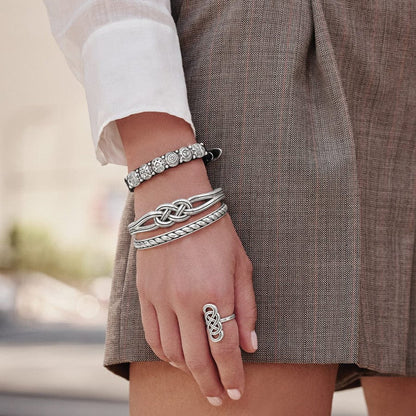 Model in brown wearing Interlok Hinged Bangle