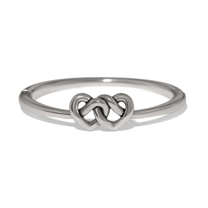 Brighton ring with silver-plated band featuring two interlocking heart motifs at the center on a white background