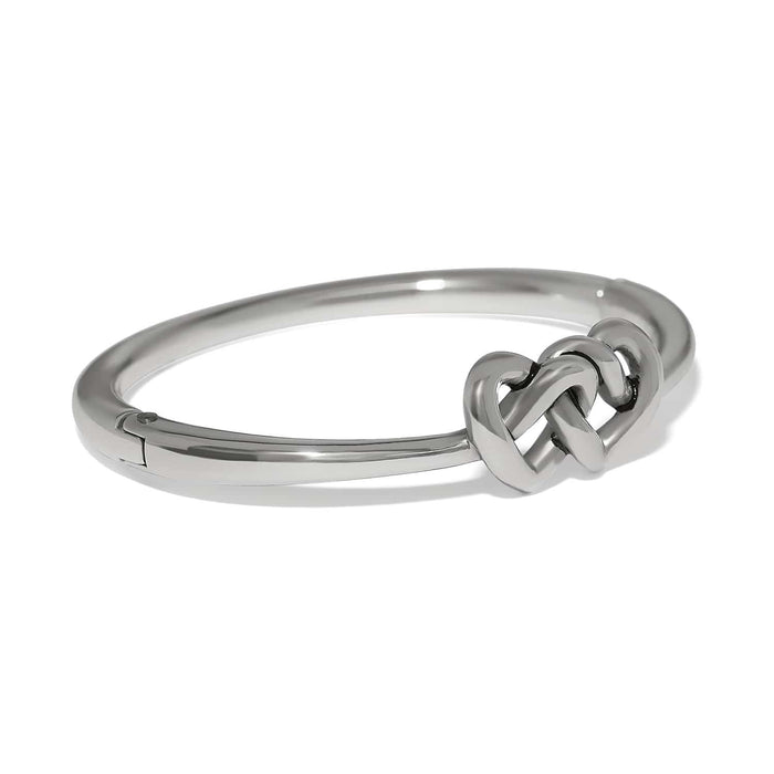Brighton bangle bracelet with silver-plated finish and interlocking heart knot centerpiece on a white background