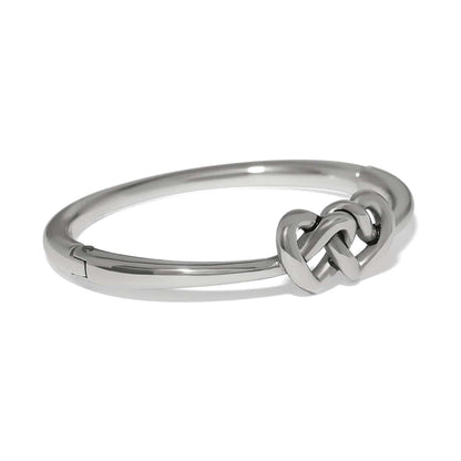 Brighton bangle bracelet with silver-plated finish and interlocking heart knot centerpiece on a white background