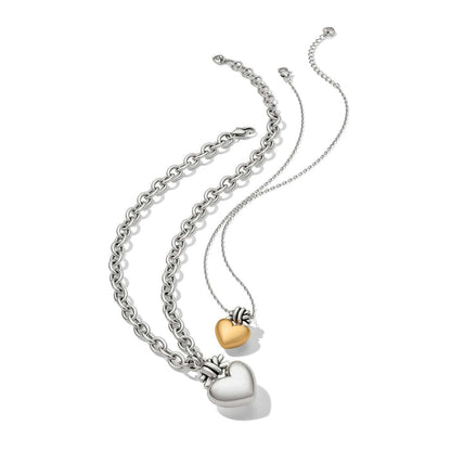 Brighton two-tone heart pendant necklaces with silver chunky chain and delicate chain holding gold heart on a white background