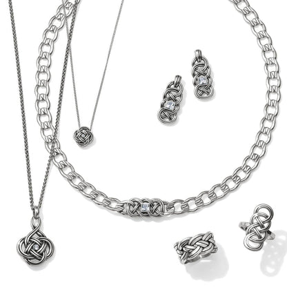 Brighton silver-plated jewelry set styled with matching Celtic knot necklaces, earrings, and rings on a white background