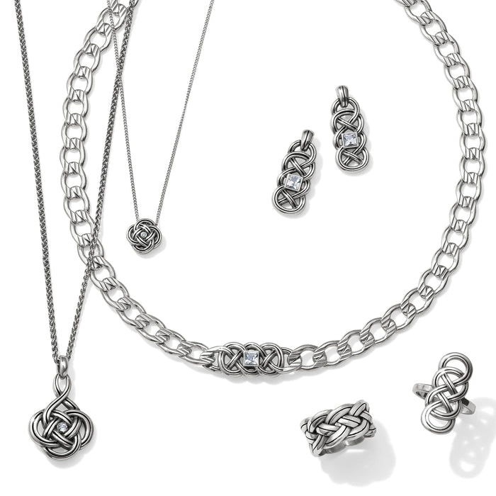 Brighton silver-plated jewelry set styled with interwoven knot pendants, matching earrings, and rings on a white background