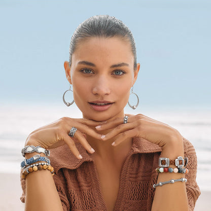 Model wearing Brighton silver-plated hoop earrings with beaded accents and coordinating Brighton accessories including rings and bracelets