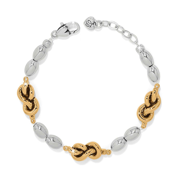 Brighton bracelet with silver-tone oval beads and gold-tone knot accents with lobster clasp on a white background
