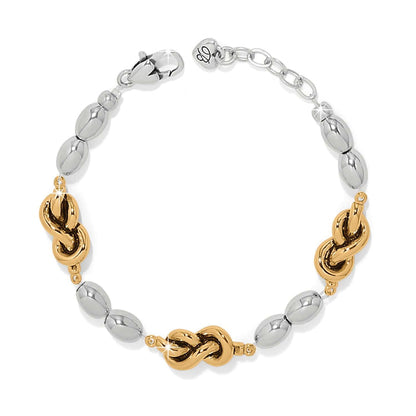 Brighton bracelet with silver-tone oval beads and gold-tone knot accents with lobster clasp on a white background