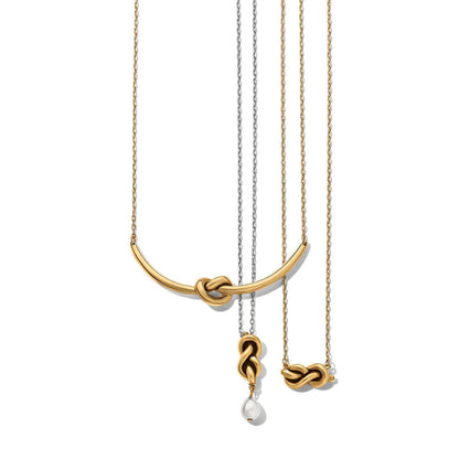 Brighton gold-plated and silver-plated necklaces with knotted bar pendants and a pearl drop accent on a white background
