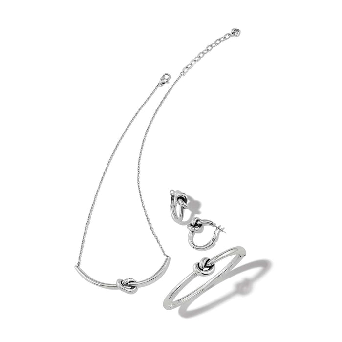 Brighton silver-tone jewelry set with knotted bar necklace, knot hoop earrings, and matching knot bangle bracelet on a white background