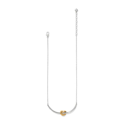 Brighton necklace with silver-tone chain and curved bar featuring a gold-tone knot accent on a white background
