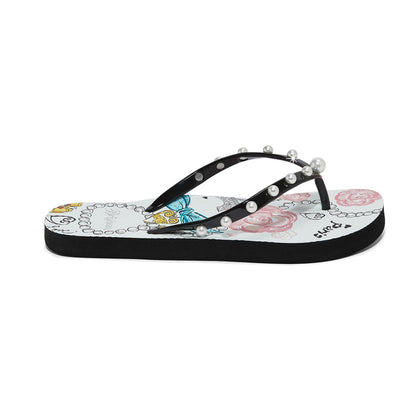 Brighton black rubber flip-flops with pearl-studded straps and Paris-themed floral print footbed on a white background