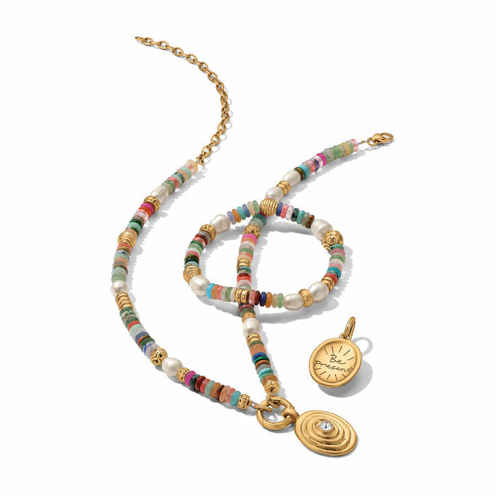 Brighton beaded necklace and bracelet styled with gold-plated charms, featuring multicolor gemstones and glass pearls on white background