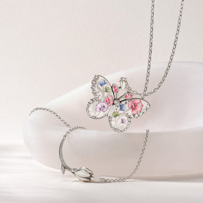 Brighton butterfly pendant necklace with floral enamel design and crystals, styled with a silver-plated tulip bracelet