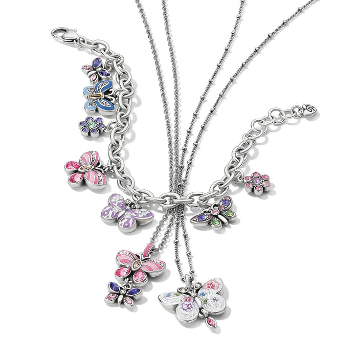 Brighton silver-plated charm bracelet and necklaces with butterfly and flower charms in enamel and crystal on a white background