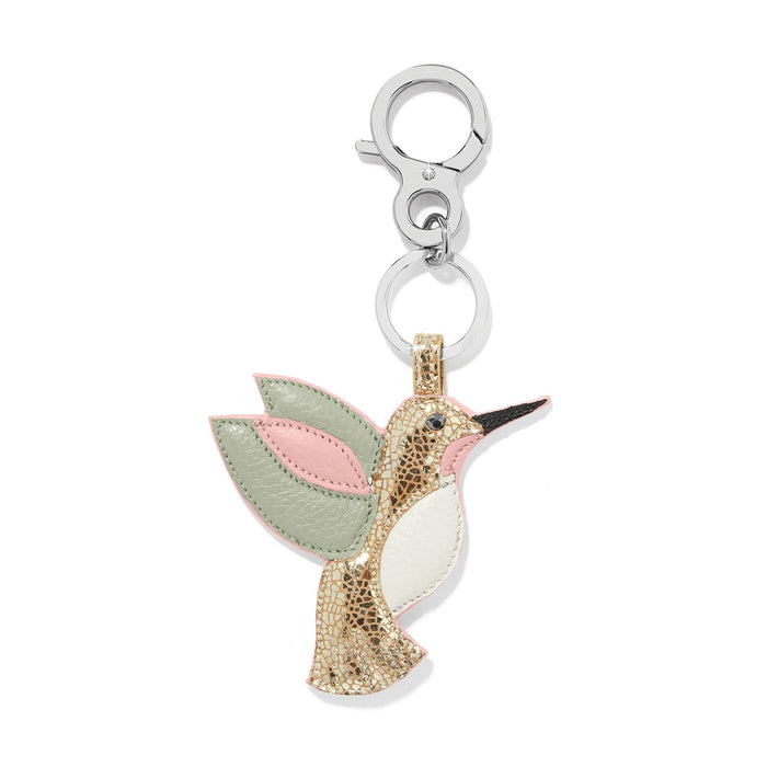 Brighton hummingbird bag charm in metallic gold leather with green and pink wings and silver-tone clasp on a white background
