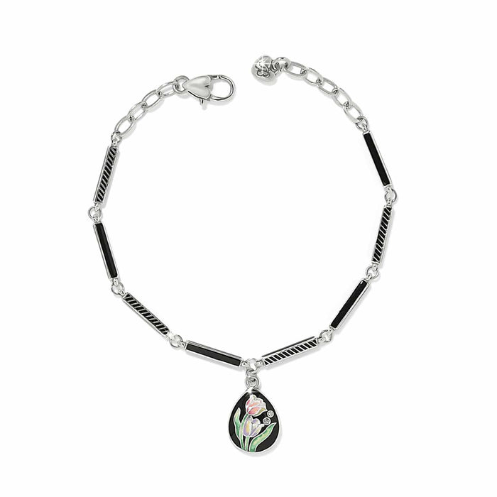 Brighton silver-plated bracelet with black enamel bar links and tulip enamel teardrop charm with crystals on a white background