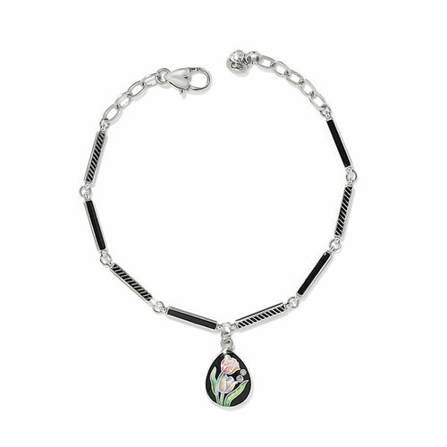 Brighton silver-plated bracelet with black enamel bar links and tulip enamel teardrop charm with crystals on a white background