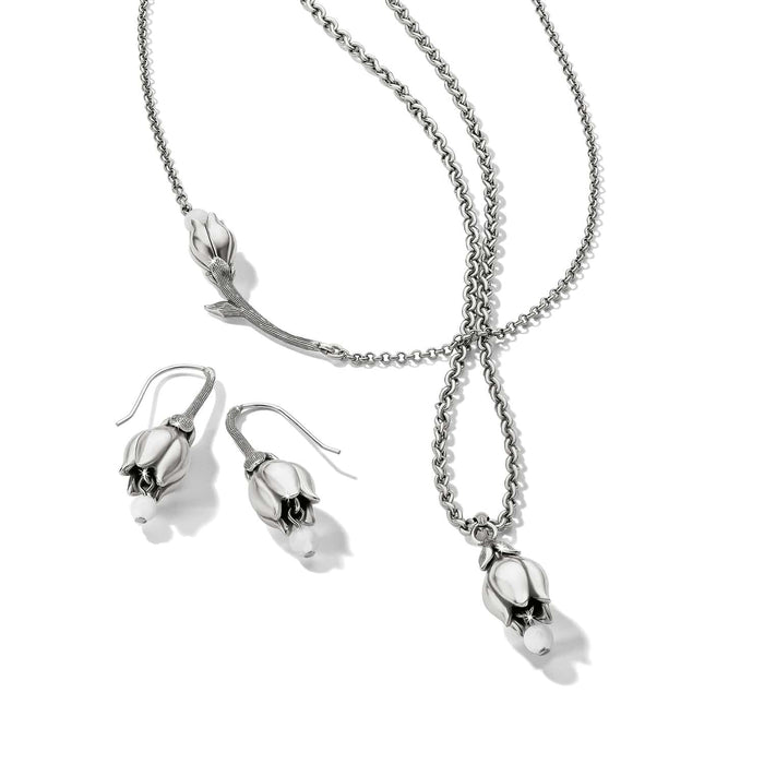 Brighton silver-plated necklace and drop earrings set with tulip flower pendants and white bead accents on a white background