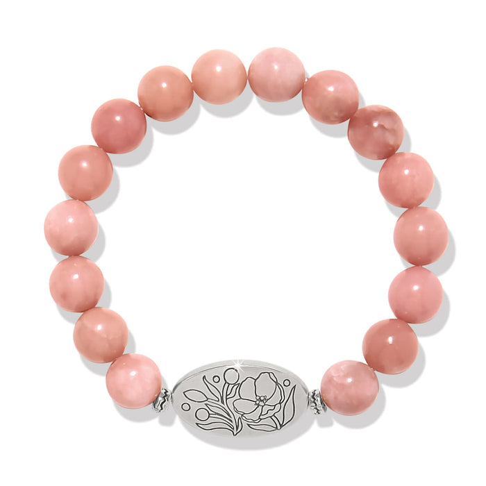 Brighton beaded bracelet with pink stone beads and silver-plated floral engraved oval centerpiece on a white background