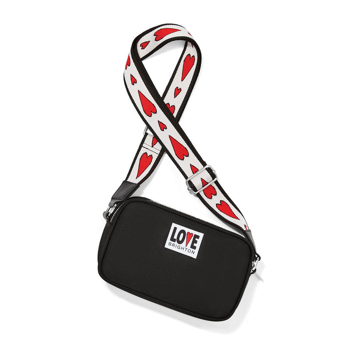 Brighton black crossbody handbag with red heart print strap and Love Brighton logo patch on a white background