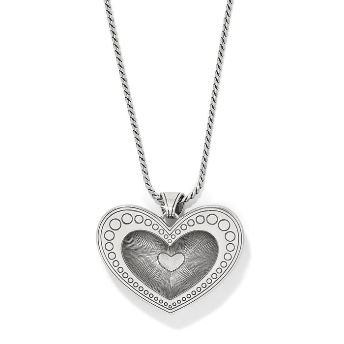 Brighton heart pendant necklace with silver-plated dotted border and engraved center heart detail on a white background