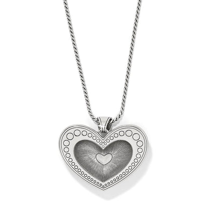 Brighton heart pendant necklace with silver-plated dotted border and engraved center heart detail on a white background