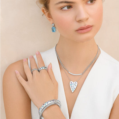 Model wearing a Brighton silver-plated heart pendant necklace with crystals and coordinating Brighton accessories