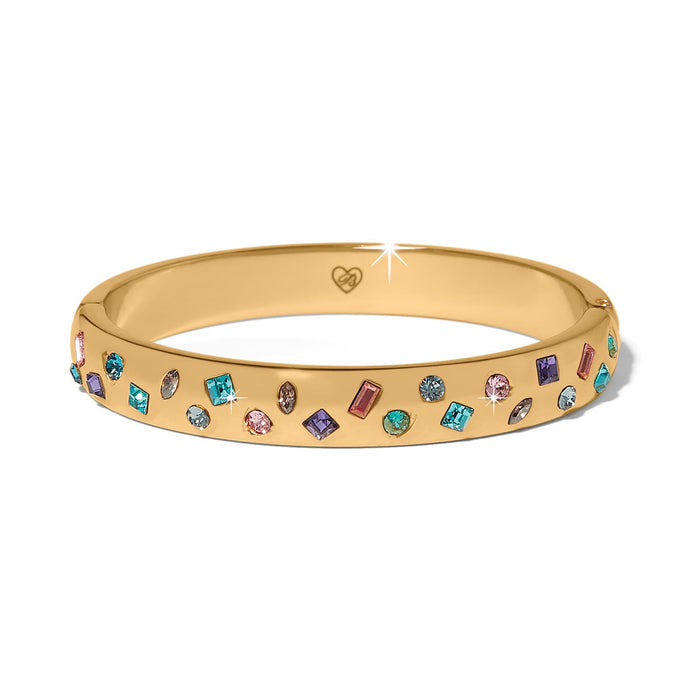 Brighton gold-plated bangle bracelet with scattered multicolored crystals in various shapes and sizes on a white background