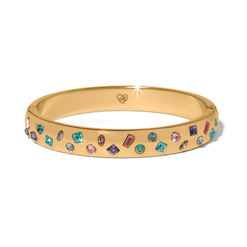 Brighton gold-plated bangle bracelet with scattered multicolored crystals in various shapes and sizes on a white background